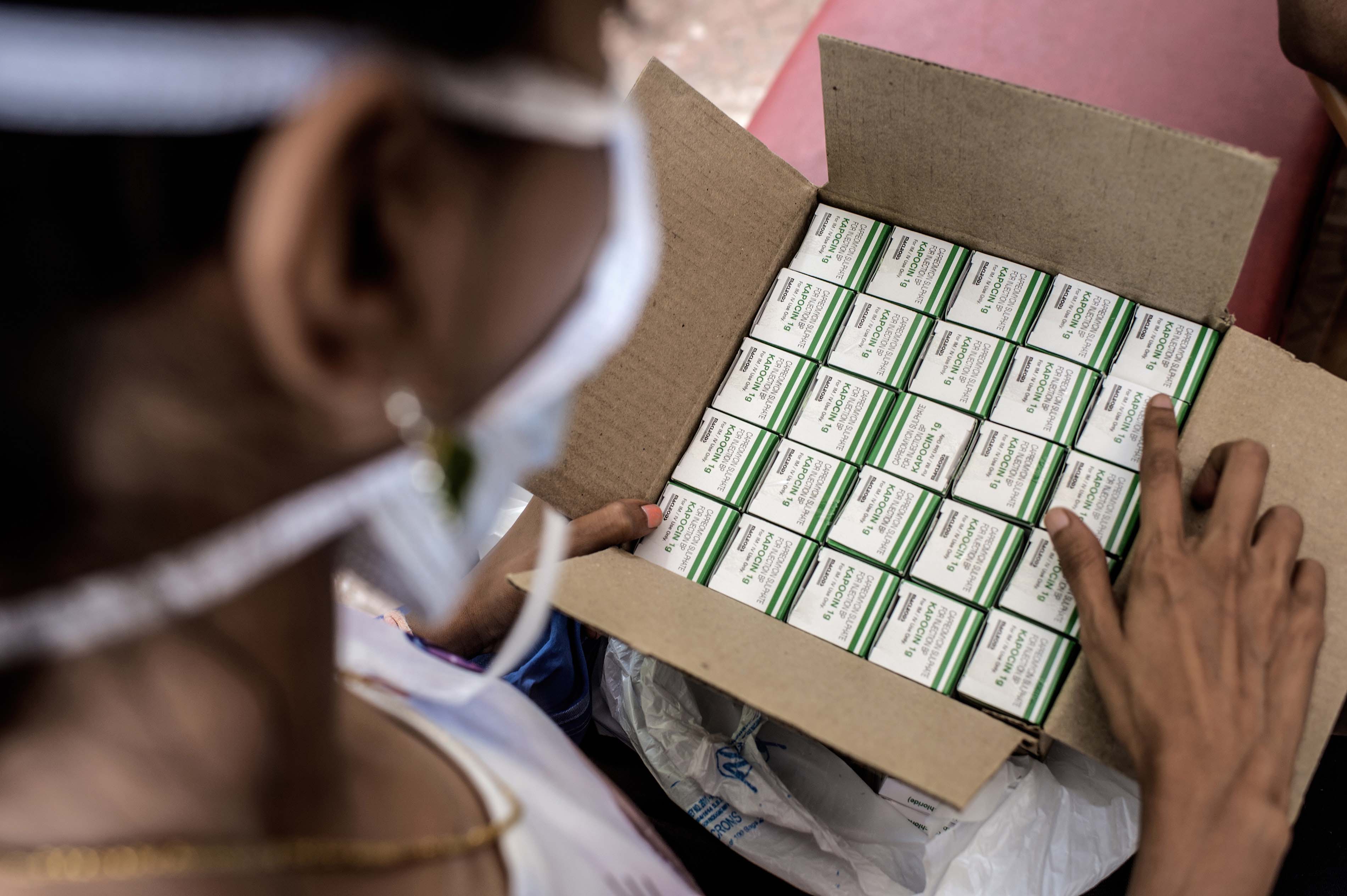Nischaya, an XDR-TB patient, looking at her TB medication at the MSF clinic in Mumbai. Photograph by Atul Loke 