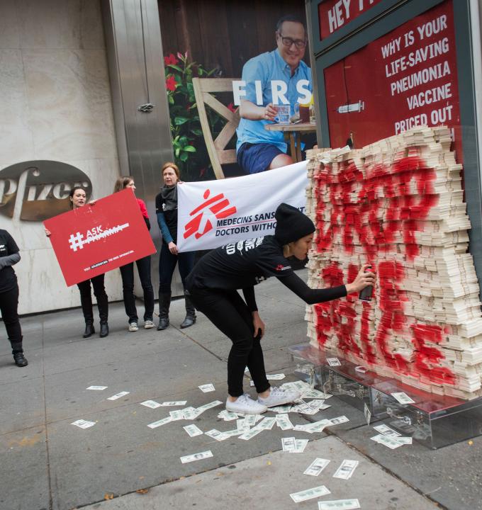 In New York, on Word Pneumonia Day 2015 (Nov 12), MSF volunteers attempted to deliver more than $17 million of fake cash - the equivalent of one day of profits from the pneumonia vaccines for Pfizer globally -  to Pfizer's CEO Ian Read. The same day, MSF launched a global petition to ask Pfizer and GlaxoSmithKline (GSK) to reduce the price of the pneumococcal vaccine to $5 dollars per child (for all three doses) in developing countries. Credit: Edwin Torres.