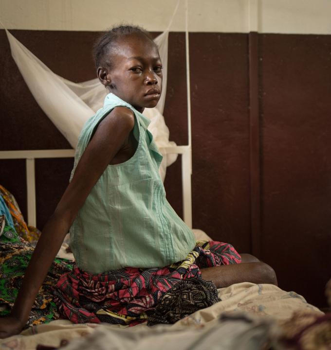 "I don’t have money for medical treatment so I did not seek help for a long time." Cynthia DOUNKEL, 26 years old, is hospitalized for the second time within a month in Hôpital communautaire in Bangui. She was referred from the MSF clinic in the displaced camp Mpoko at the airport of Bangui. She is HIV positive, has Tuberculosis and suffers from Kaposi's sarcoma. She is three months pregnant. 09 July 2016 - Hôpital communautaire, Bangui, Central African Republic. Photograph by Alexis Huguet
