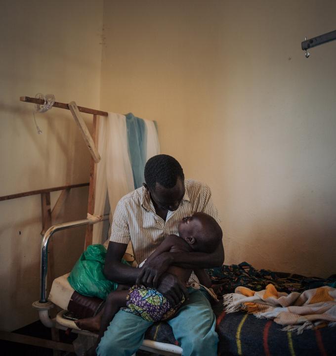 Joseph Drobho Giria holds his two-year-old daughter, Bhileru Drobho, who suffers from measles, in the measles unit run by MSF at Biringi Hospital, Ituri Province, northeastern Democratic Republic of Congo.