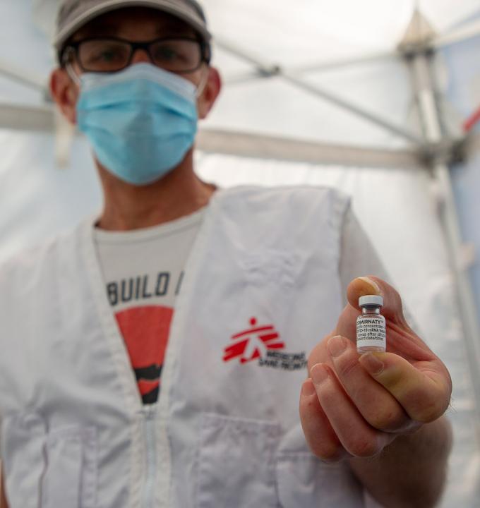 Jérôme Tognotti, MSF nurse supervisor, holding a vial of COVID vaccine used by teams to vaccinate homeless and migrant people