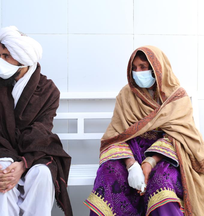 Bibi Shahisto waits to see the doctor with her son on the women's side of the Médecins Sans Frontières (MSF) drug-resistant tuberculosis (DR-TB) hospital in Kandahar city, Kandahar Province, Afghanistan. Photo credit: Lynzy Billing