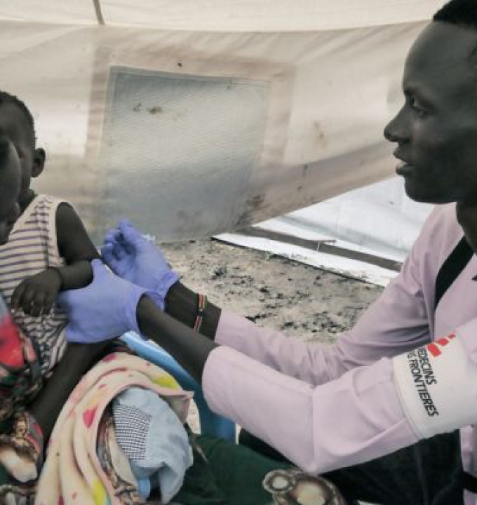 MSF nurse Gatwech Tuoch immunises a child against measles at the MSF Mobile Clinic in Bulukat, Upper Nile State, South Sudan.