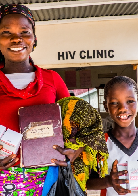 Tsandia and Kristian with their medicins and recordbook, happy to get treatment, at the HIV department of Arua Regional hospital-Uganda