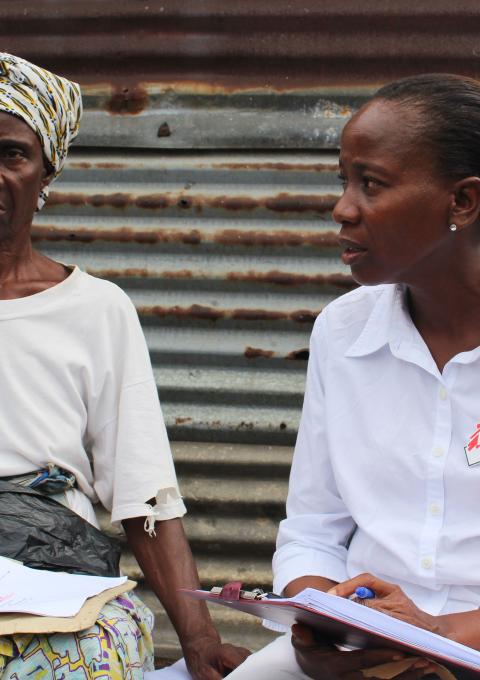 Ebola survivor, Jesse Wolatee, 65yrs, explains to an MSF Ebola survivor clinic staff post-Ebola syndrome she is experiencing.