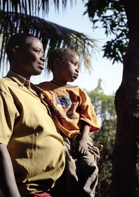 Matateu and his child, seropositive, having a walk in Ferroviario, Mozambique. Matateu, 41 years old, is under ARV treatment since 2003.