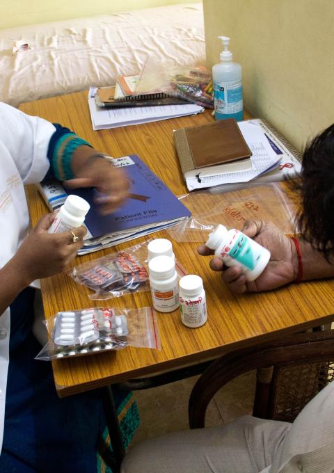 MSF Nurse dispensing 3rd line ARTs to patient living with HIV.