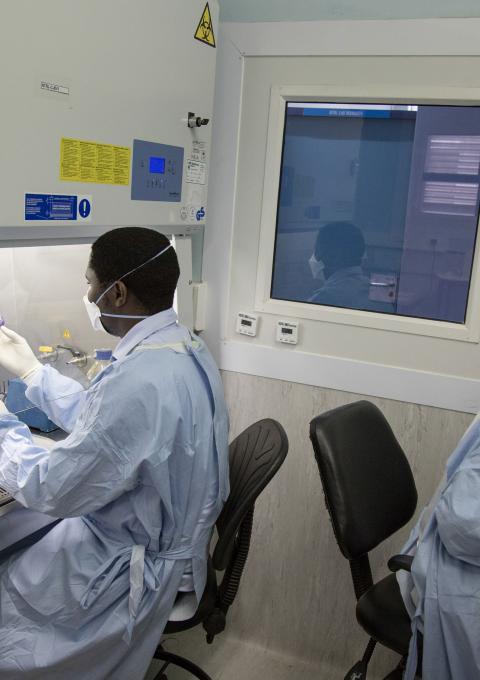 Lab technologists preparing sputum samples to realize bacteria cultures. Kwanele Dlamini (left), MSF Lab Technologist, & Nobuhle Matsabula (right), MoH Microscopist. National TB Reference Laboratory, Government Hospital, Mbabane, Swaziland.