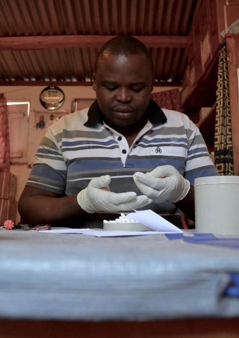The pharmacist in Zémio, Alain, prepares Raymond’s order: ninety days’ worth of HIV medications for the 26 people in his CAG group. December 2016.  Raymond was health worker in MSF supported health center of Djema, in the south east of Central African Republic (CAR). He was also a patient in the community based HIV program MSF launched in Zemio.