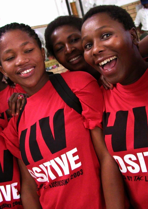 Treatment Action Campaign (TAC) activists wear "HIV Positive" t-shirts during Mr Mandela's visit to Siyaphila la HIV Treatment Program hosted by MSF and the Nelson Mandela Foundation. The event was held at the Lusikiki Teacher's Training College.