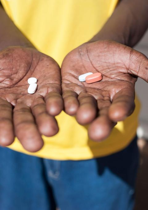 A man holds antiretroviral drugs at an activist meeting in Soshanguve, a township outside of Pretoria on April 16, 2015.