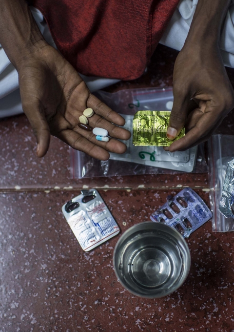 XDR-TB patient Hanif, taking his daily TB medication at home in the Govandi area of Mumbai.