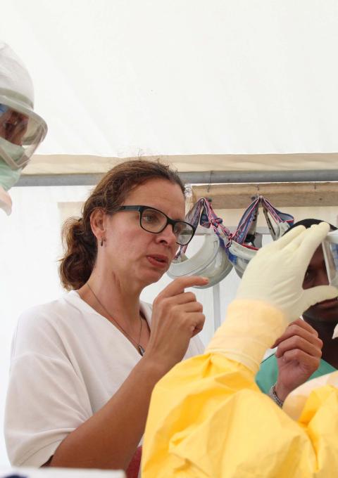 Emergency coordinator Anja Wolz (centre) reminds MSF International President Dr Joanne Liu (right) to adjust goggles so that it fits comfortably and securely. Photograph by P.K. Lee