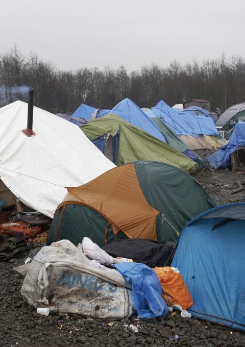Tents and debris litter the site of a the refugee camp in Grande Synthe near Dunkirk in northern France. Some 2,500 refugees have settled here whilst they attempt to cross to the United Kingdom to seek asylum. Grande Synthe, Dunkirk: A Gill visits the refugee camps of Calais and Grande Synthe in Dunkirk. Photograph by Jon Levy
