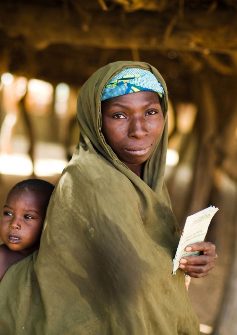 A woman who took her child to get vaccinated against meningitis holds the child's vaccination card at a vaccination site in Safa Dougoumi, Dosso Region, Niger on Monday April 20, 2009. Photograph by Olivier Asselin