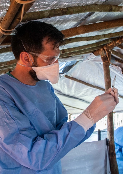 Luis Encinas, Ebola expert and nurse, prepares a vaccine.