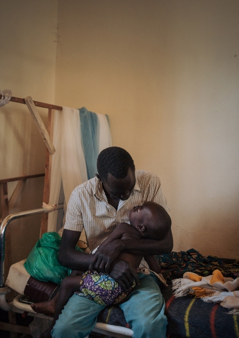 Joseph Drobho Giria holds his two-year-old daughter, Bhileru Drobho, who suffers from measles, in the measles unit run by MSF at Biringi Hospital, Ituri Province, northeastern Democratic Republic of Congo.
