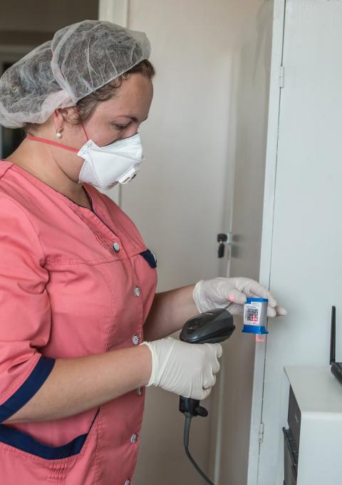 Laboratory assistant Iuliia Karbivska is scanning an Xpert MTB/Rif cartridge for use in the GeneXpert machine provided by MSF for the laboratory of the Zhytomyr Regional TB Dispensary.