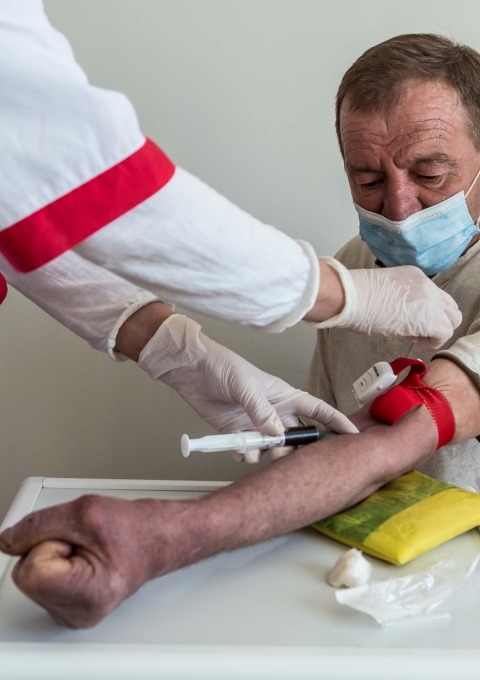 A nurse conducts a blood test on a DR-TB patient Dmitri Karpuk (name changed), 61 at the TB facility in Novograd-Volynsk district, Zhytomyr region, Ukraine.