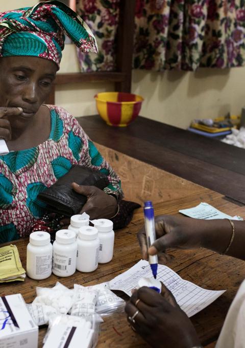Finda collects her six months of ART and related drugs at MSF-supported pharmacy as part of her months consultation at the MSF-supported HIV outpatient department at Matam health centre, Conakry, Guinea