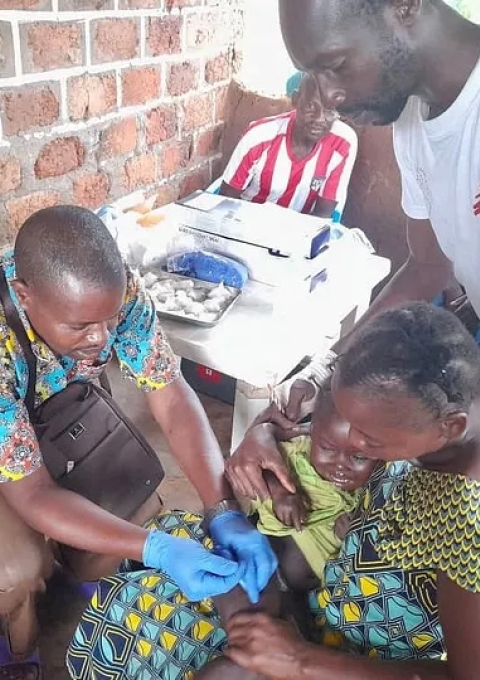 A baby is vaccinated against measles and whooping cough by a member of MSF’s emergency team in Satema, in the south of Central African Republic