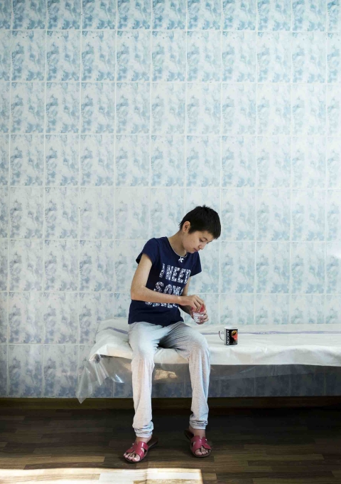 A teenage girl takes her daily dose of medicine under the supervision of hospital staff at the Osh Paediatric TB hospital in Kyrgyzstan.