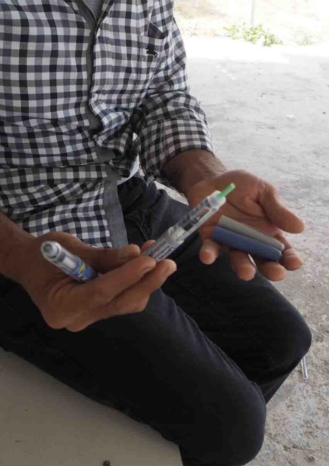 Anis showing his insulin in pens. Athens, Greece.