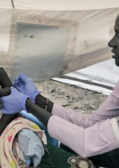 MSF nurse Gatwech Tuoch immunises a child against measles at the MSF Mobile Clinic in Bulukat, Upper Nile State, South Sudan.
