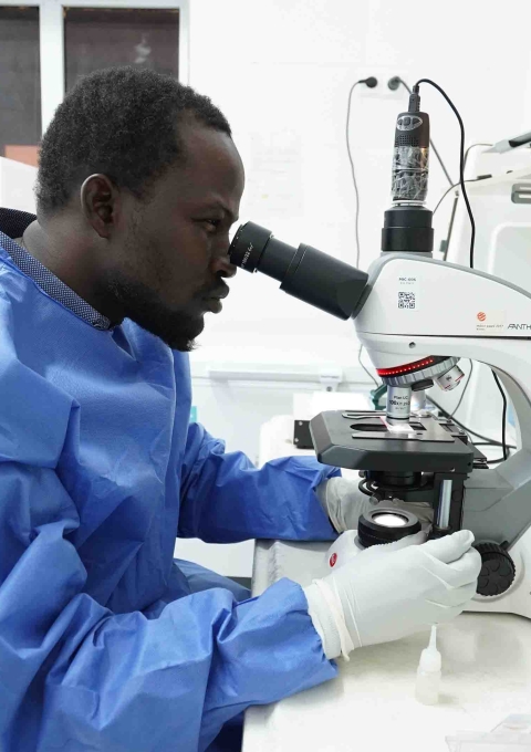 MSF lab technician Babukar Kolo observing samples in the mini lab at the Kushari Comprehensive Emergency Obstetric and Newborn Care (CEMONC) facility in Maiduguri, Borno State, Nigeria.
