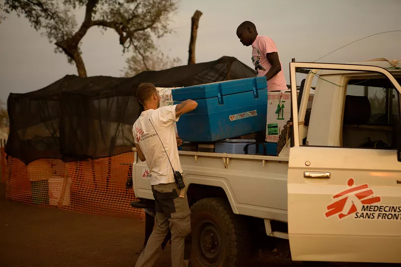 07:20 in the morning. Logisticians off-load vaccines at one of the vaccination sites. The sites open at 8 and usually a big crowd of children is waiting for the vaccination team when they arrive.