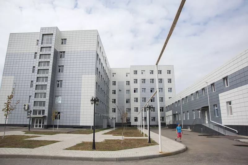 Malika, 48, a journalist from Grozny and an XDR TB patient, walking across the premises of the Republican TB Dispensary in Grozny, Chechnya