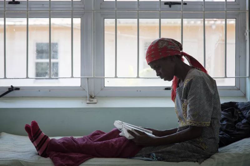 Tholakele, 39, an MDR-TB patient, was admitted in April 2016. She now spends her days reading her bible. National TB Hospital, Moneni, Manzini Region, Swaziland.