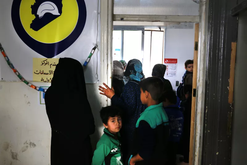Mothers in the health center in Al-Atareb wait to get their children immunized with a multi-antigen vaccine provided by MSF in west Aleppo countryside.
