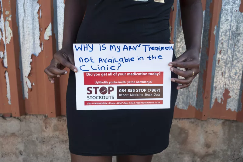 A woman holds a sign at the Stop Stock Outs (SSP) activist meeting in Soshanguve, a township outside of Pretoria on April 16, 2015.