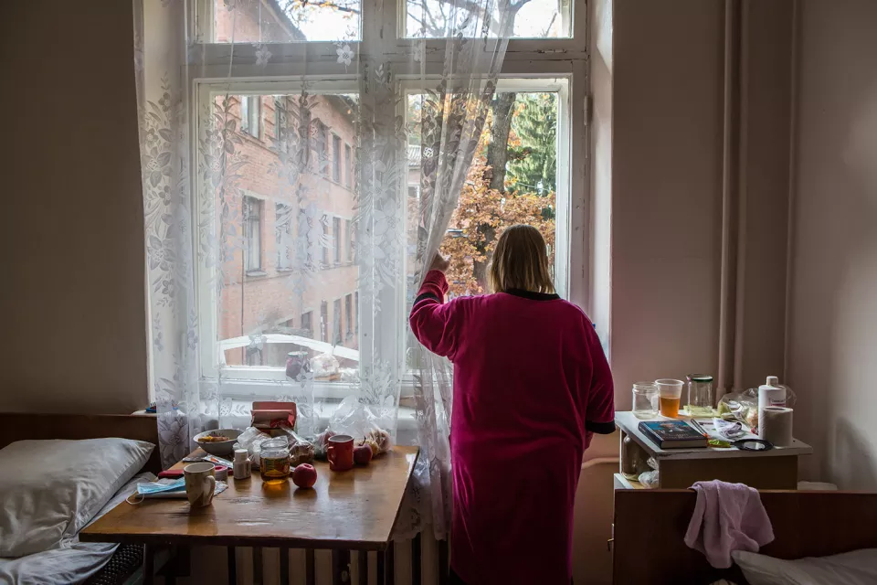 A patient with multidrug-resistant tuberculosis (MDR-TB) looks out of the window of her room at the Zhytomyr Regional TB Dispensary.