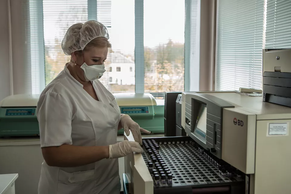 Laboratory assistant Nataliia Turovska checks the Bactec for positive tubes from TB suspect patients in the laboratory of the Zhytomyr Regional TB Dispensary.