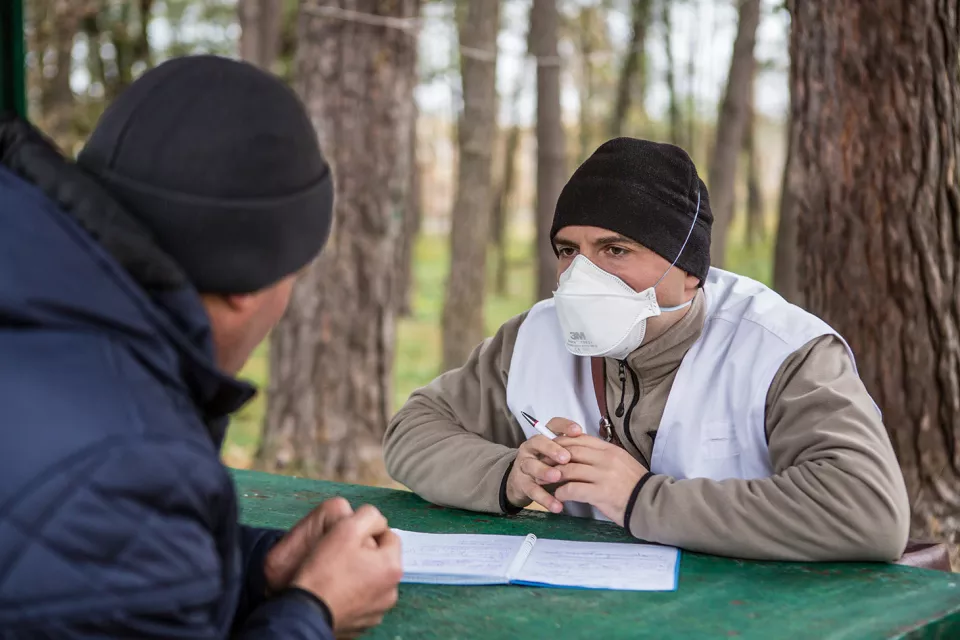 Volodymyr Lychagin, MSF psychologist, during a therapy session with TB patient Ihor Lavrentiev, 40, outside of the Zhytomyr Regional TB Dispensary.