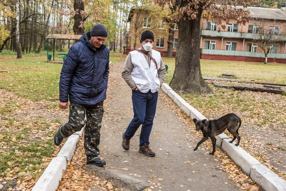 Volodymyr Lychagin, MSF psychologist, walks with TB patient Ihor Lavrentiev, 40, during a therapy session.