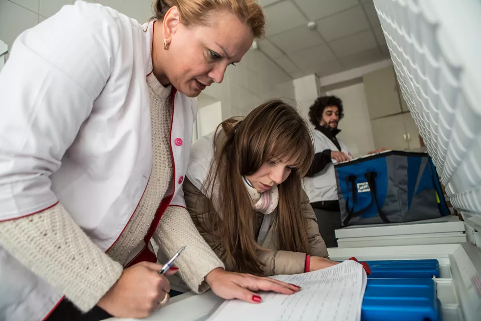 Iryna Shchyra, deputy head of the pharmacy, checking newly arrived medication before putting it in the fridge in the pharmacy of the Zhytomyr Regional TB Dispensary.