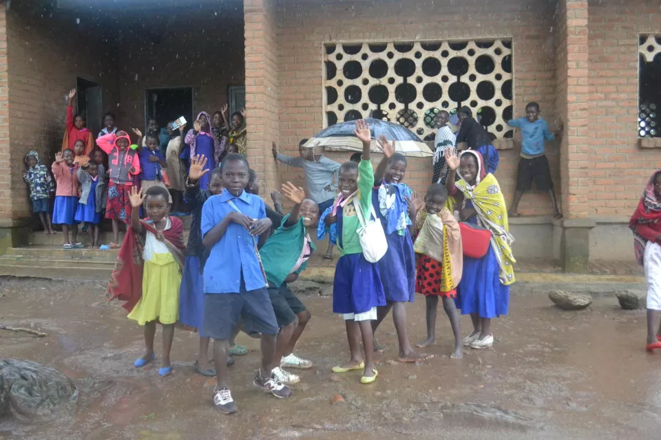 At the end of the session, the girls head back to class, stopping to wave and play along the way.