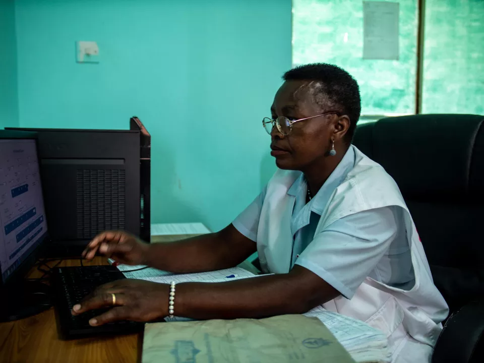 MSF Nurse Mentor Sister Mercy Mandizvo inputs patient details in the VIAC (Visual Inspection with Acetic Acid and Cervicography) room at Chitando Rural Health Centre. Gutu, Zimbabwe.