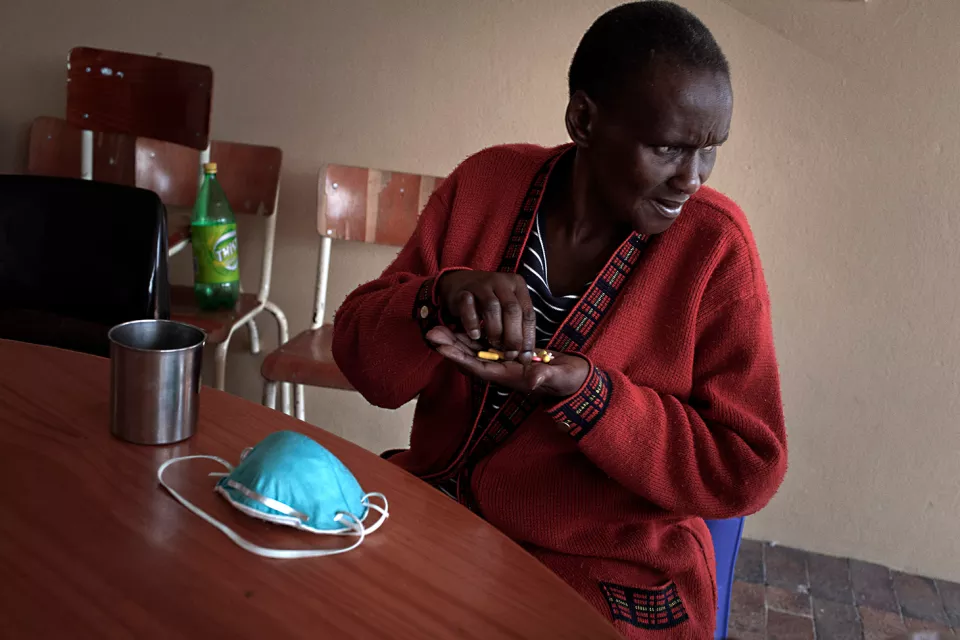 Jonas Cikizwa, a woman infected with extremely drug-resistant tuberculosis (XDR-TB), HIV and diabetes, takes her pills. Lizo Nobanda TB Care Centre, in Khayelitsha township, near Cape Town, South Africa. 