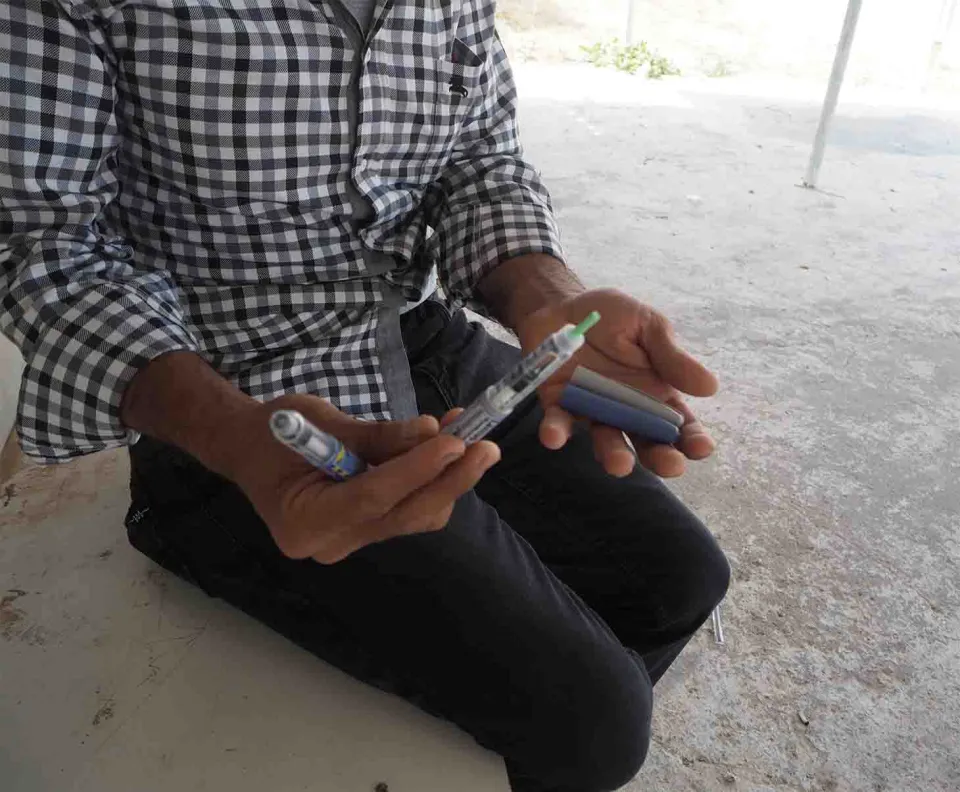 Anis showing his insulin in pens. Athens, Greece.