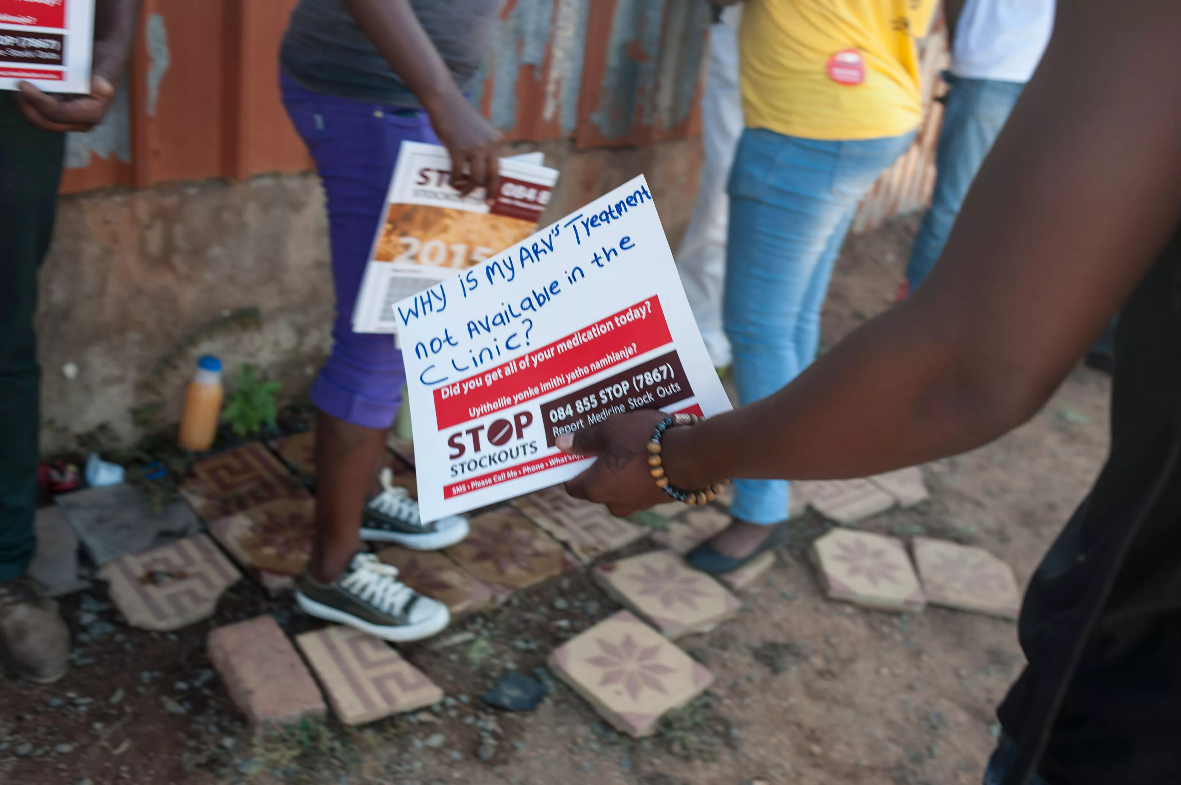 A woman holds a sign at the Stop Stock Outs (SSP) activist meeting in Soshanguve, a township outside of Pretoria on April 16, 2015.
