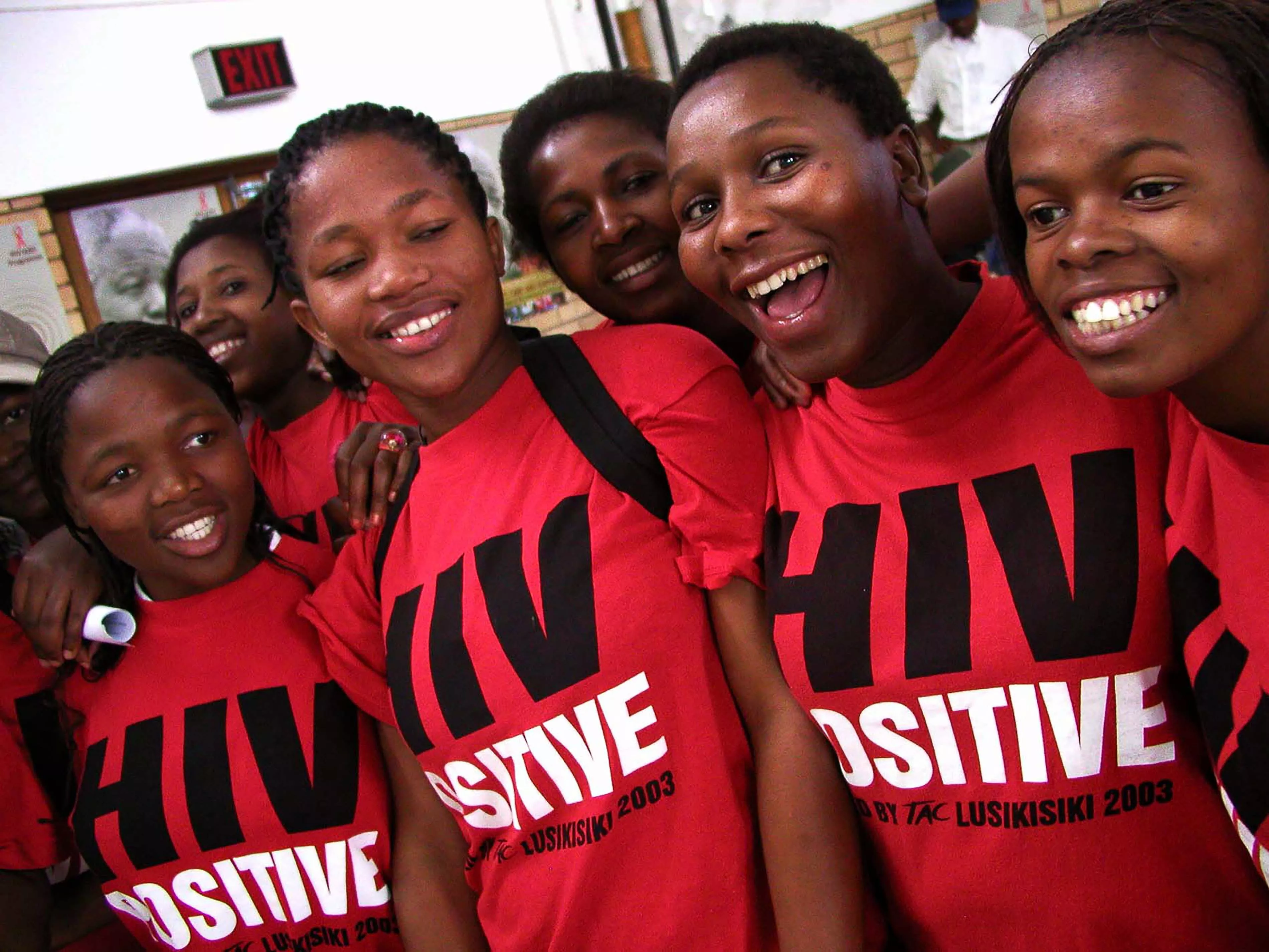 Treatment Action Campaign (TAC) activists wear "HIV Positive" t-shirts during Mr Mandela's visit to Siyaphila la HIV Treatment Program hosted by MSF and the Nelson Mandela Foundation. The event was held at the Lusikiki Teacher's Training College.