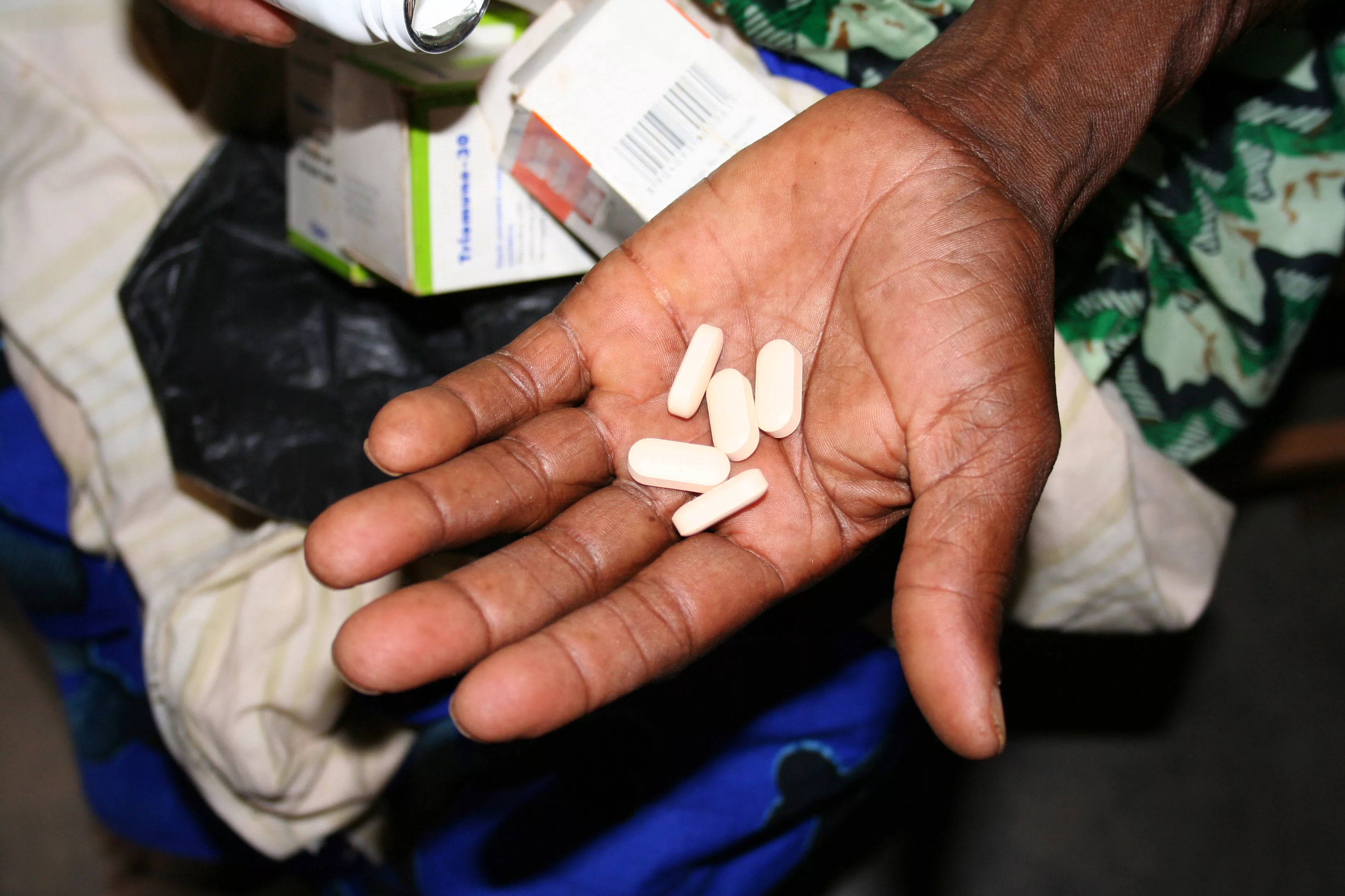 a woman receives a 2-month supply of high quality, affordable, generic antiretroviral medicines, which are sourced by the Government of Malawi and distributed by MSF.