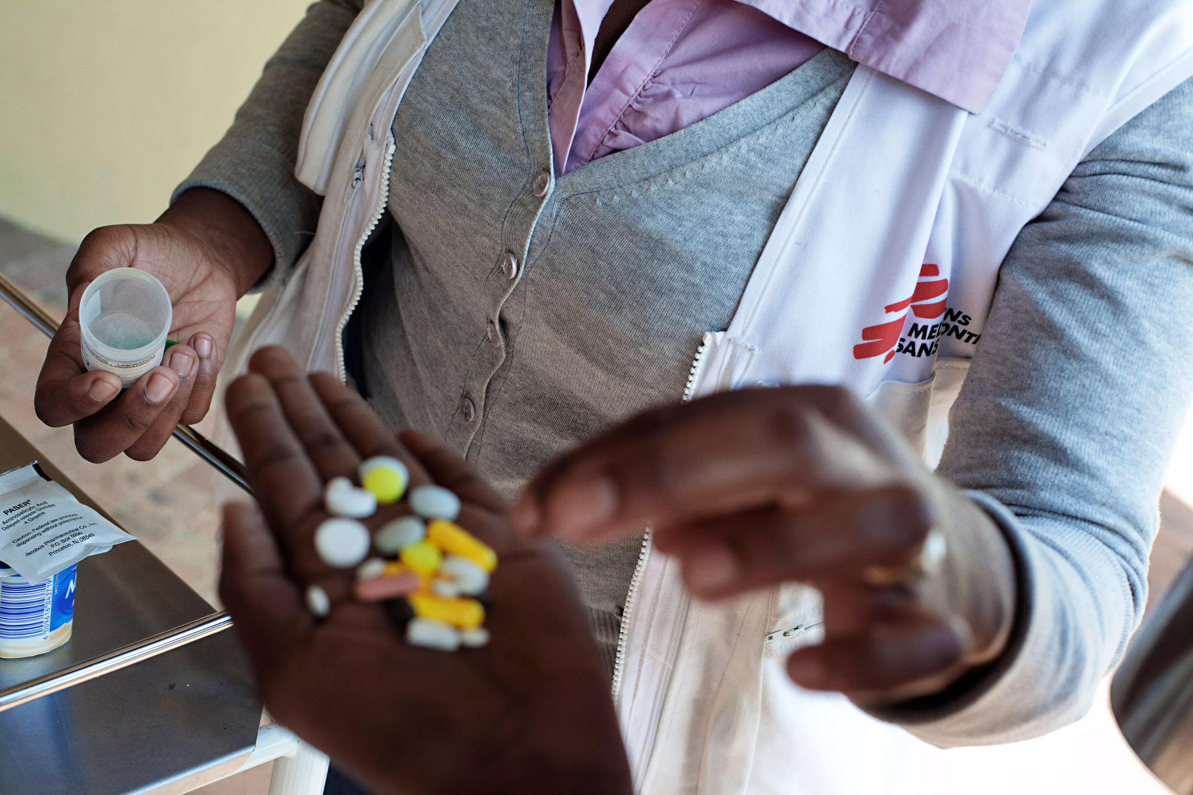 Nolitha Tsilana, a MSF nurse, delivers TB pills to a patient at Lizo Nobanda TB Care Centre in Khayelitsha township, Cape Town.