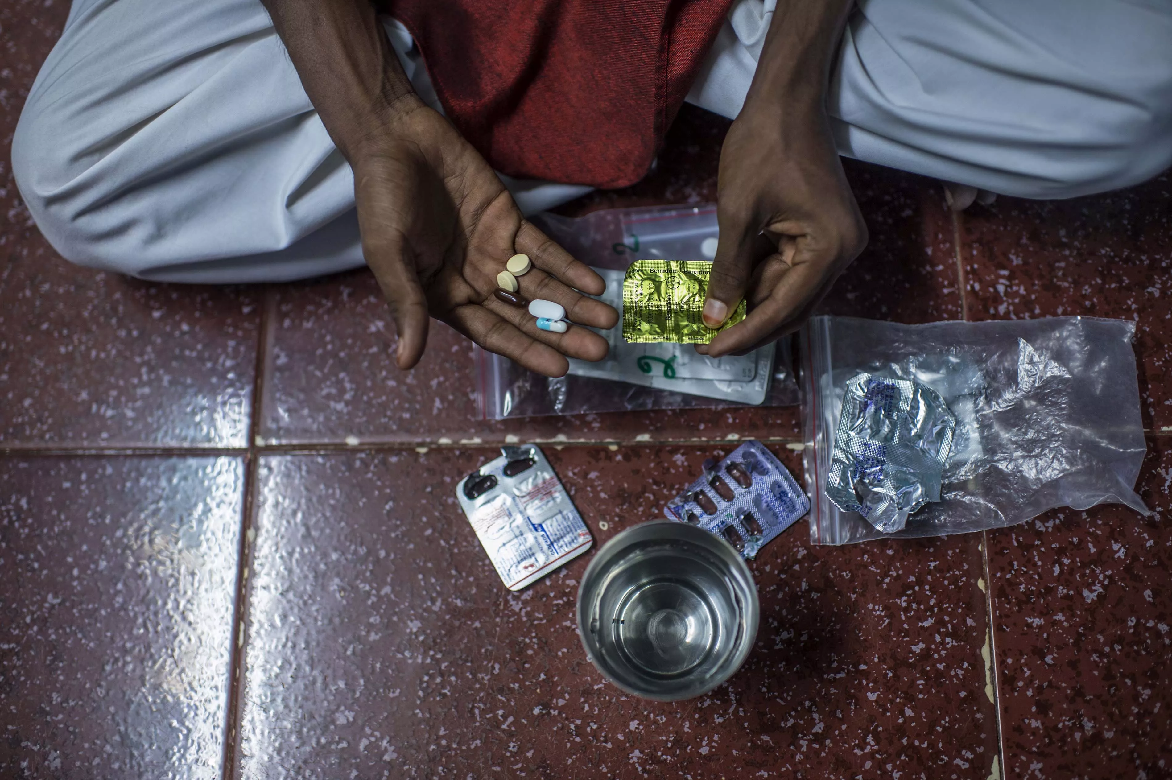 XDR-TB patient Hanif, taking his daily TB medication at home in the Govandi area of Mumbai.