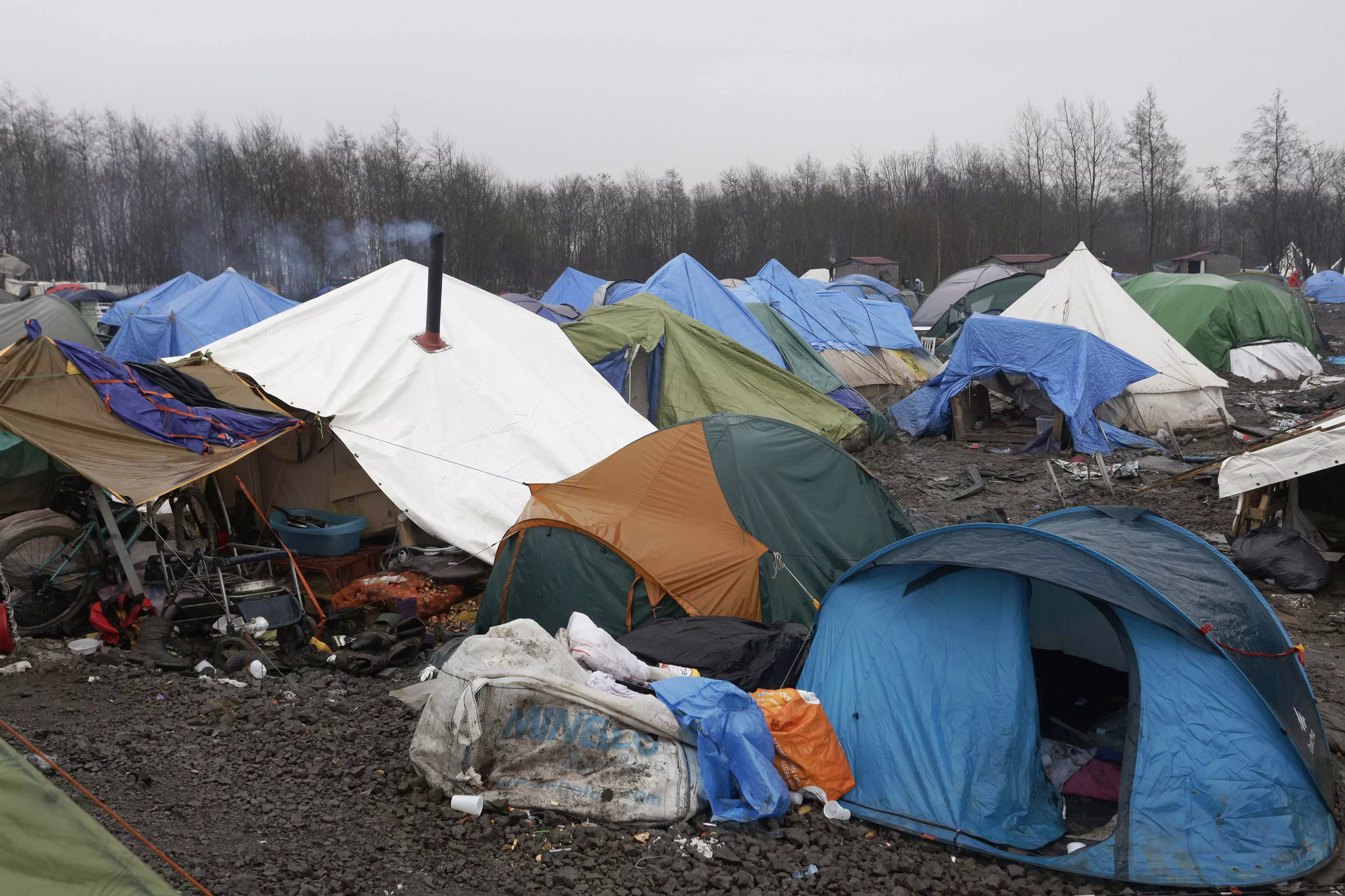 Tents and debris litter the site of a the refugee camp in Grande Synthe near Dunkirk in northern France. Some 2,500 refugees have settled here whilst they attempt to cross to the United Kingdom to seek asylum. Grande Synthe, Dunkirk: A Gill visits the refugee camps of Calais and Grande Synthe in Dunkirk. Photograph by Jon Levy