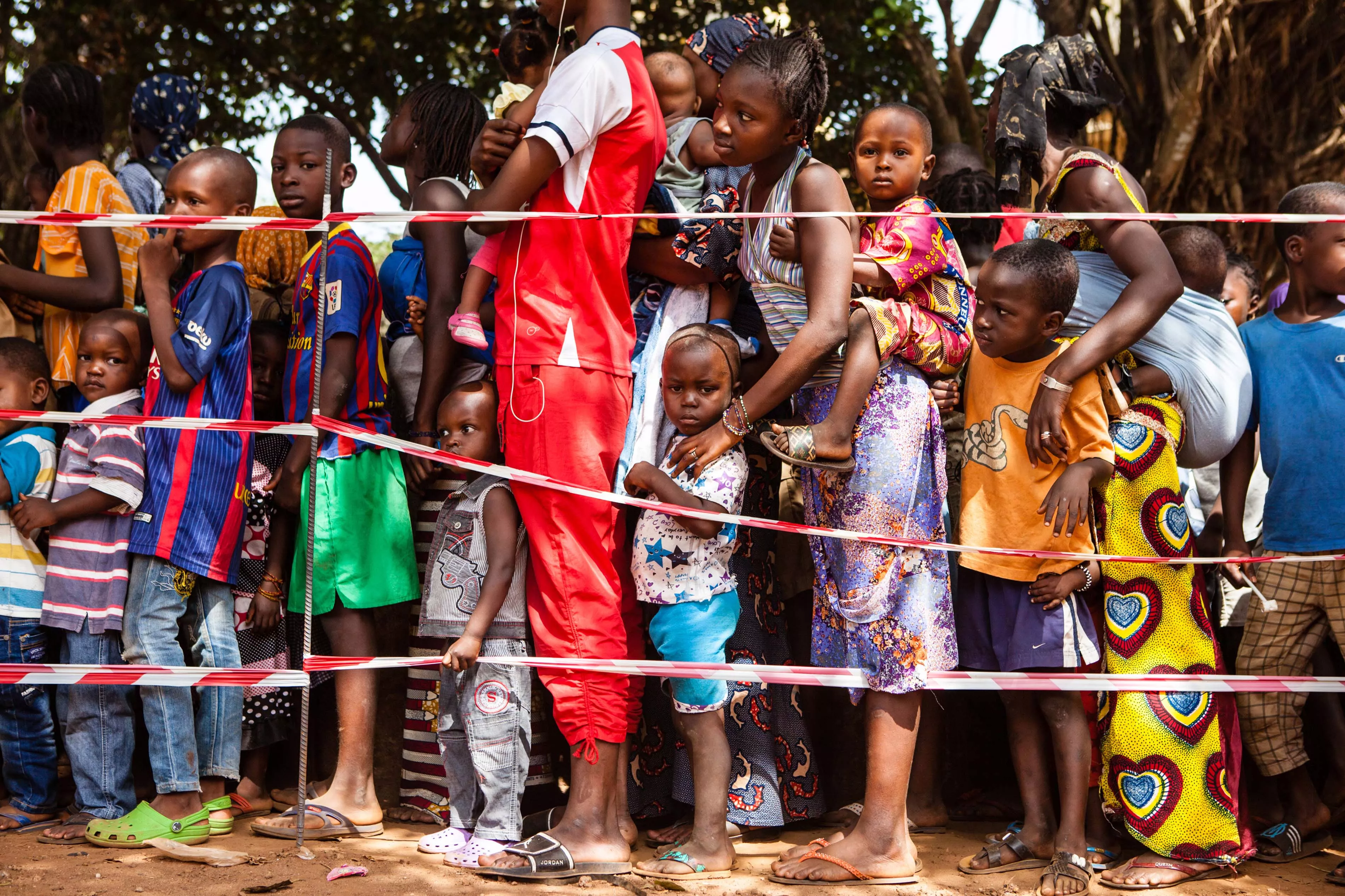 Children queue at a vaccination point in the commune of Matoto, Conakry, Guinea. Médecins Sans Frontières/Doctors without Borders (MSF) is launching a large scale measles vaccination campaign in Conakry, the capital of Guina. Since the beginning of the year there have been 3468 confirmed cases and 14 deaths dues to measles in Guinea. Conakry and Nzérékoré are the most affected districts. Photograph by Markel Redondo